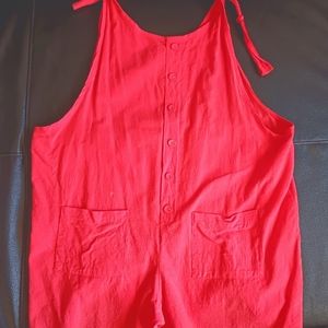 Romper in coral (reddish pink)